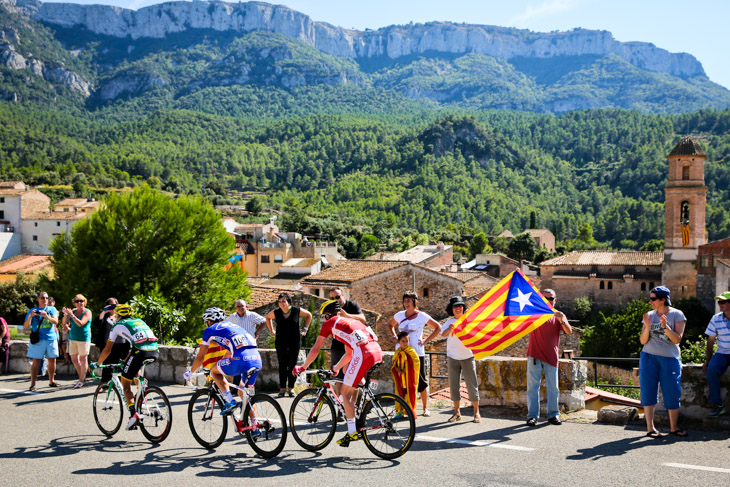 独立を訴えるカタルーニャ州旗が振られる中を逃げるセドリック・ピノー(フランス、FDJ.fr)ら