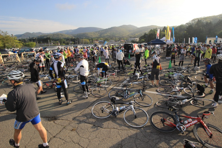 朝日が眩しいスタート地点の軽井沢プリンスホテルスキー場に続々と集まってくる参加者