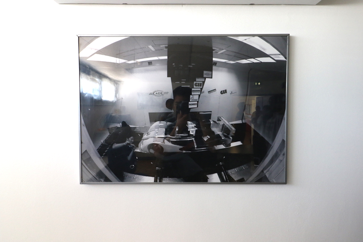 研究室の壁に掛けられていたレーシングカーの開発風景。ACEは自動車や航空宇宙関連の開発を主眼に置いている