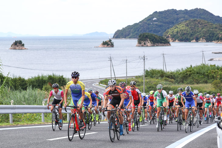 少年男子1周目、大三島最南端を行くメイン集団。先頭は地元愛媛の日野泰誠(松山城南高)