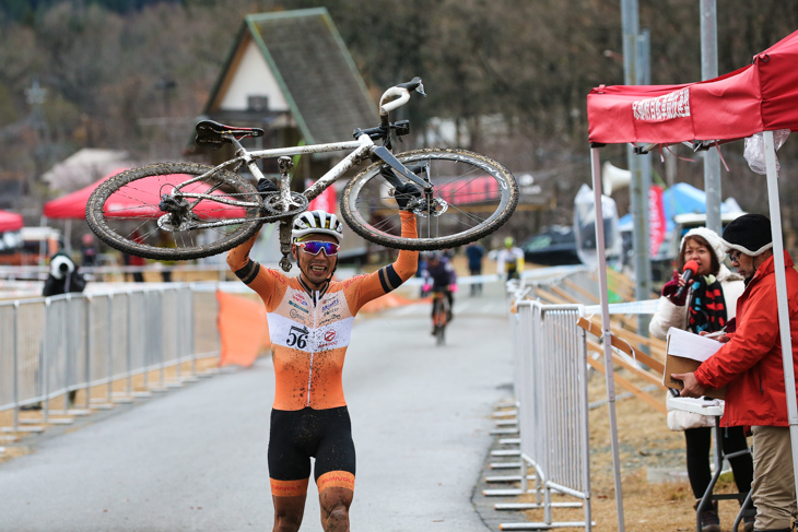 男子マスターズ40-44　バイクを掲げてフィニッシュする筧五郎（56サイクル）