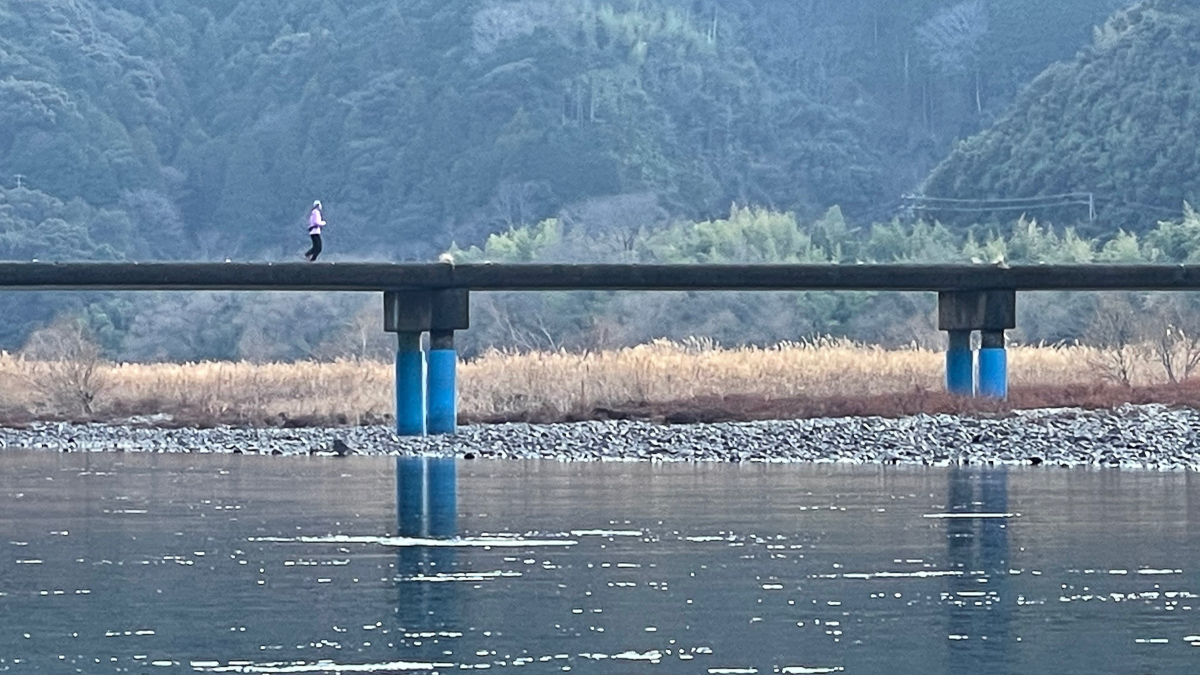 沈下橋の上をジョギングする地元の人