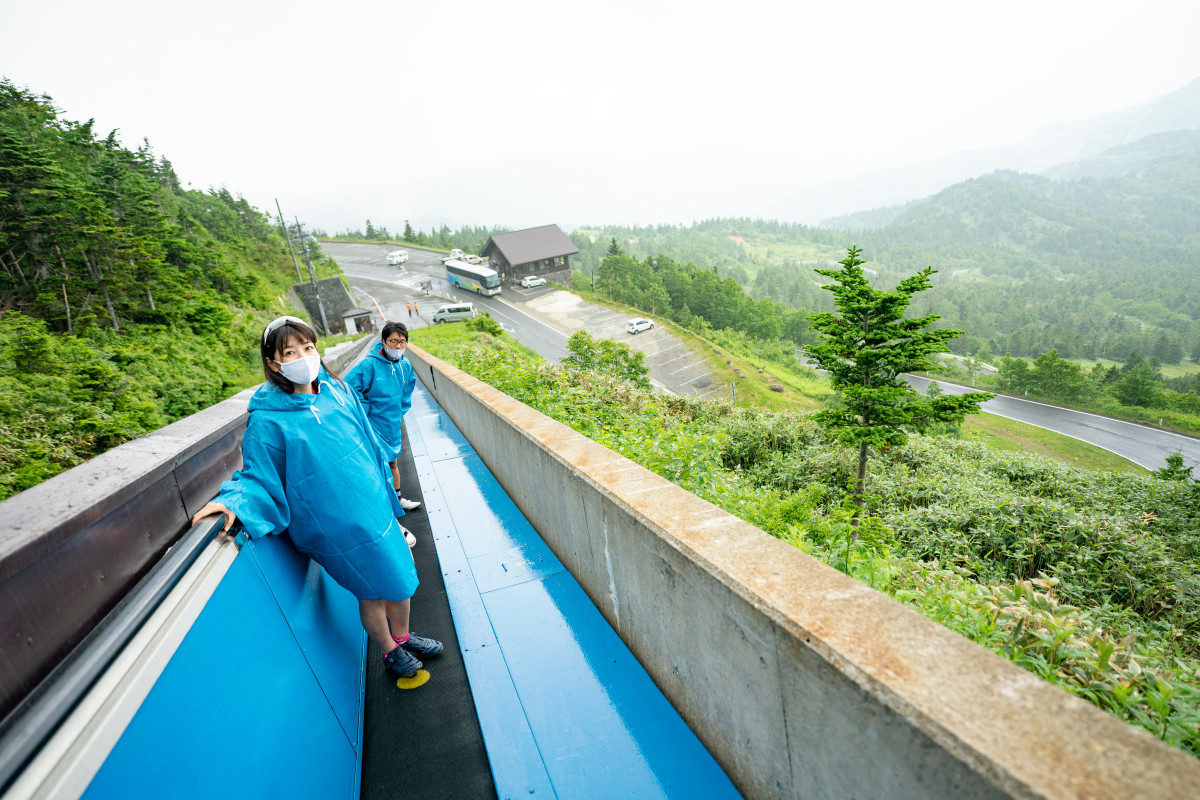 スカイレーターで横手山山頂へ。この日はあいにくの雨模様でカッパを着用