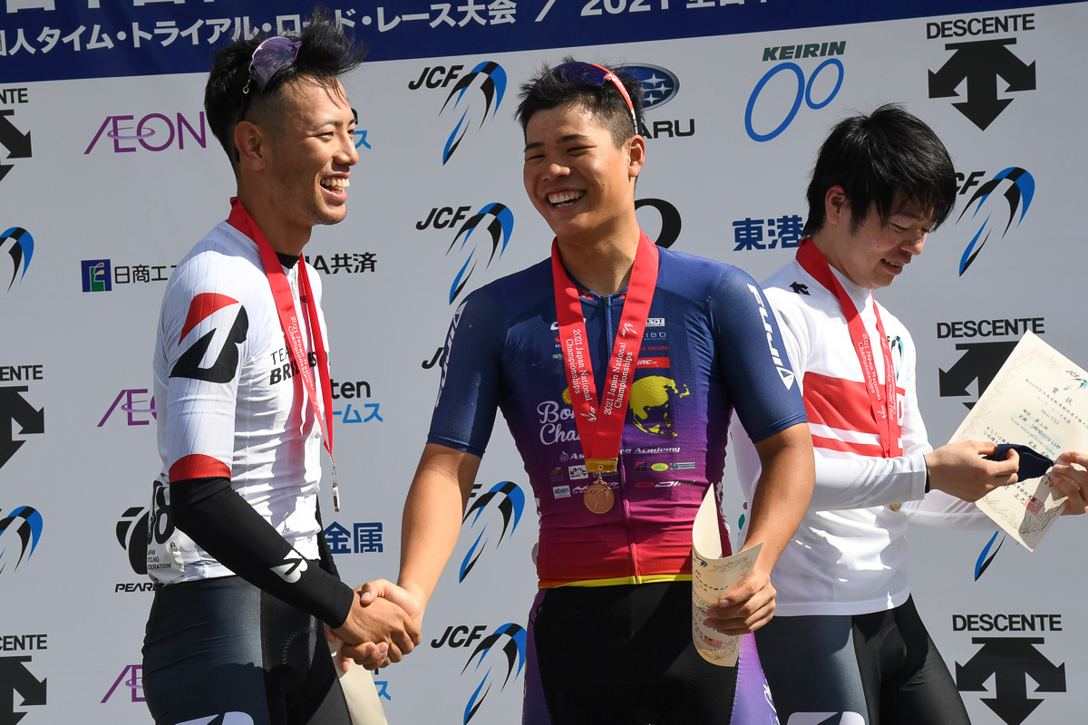 3位の寺田吉騎（Asia Cycling Academy）が山本哲夫と握手を交わす